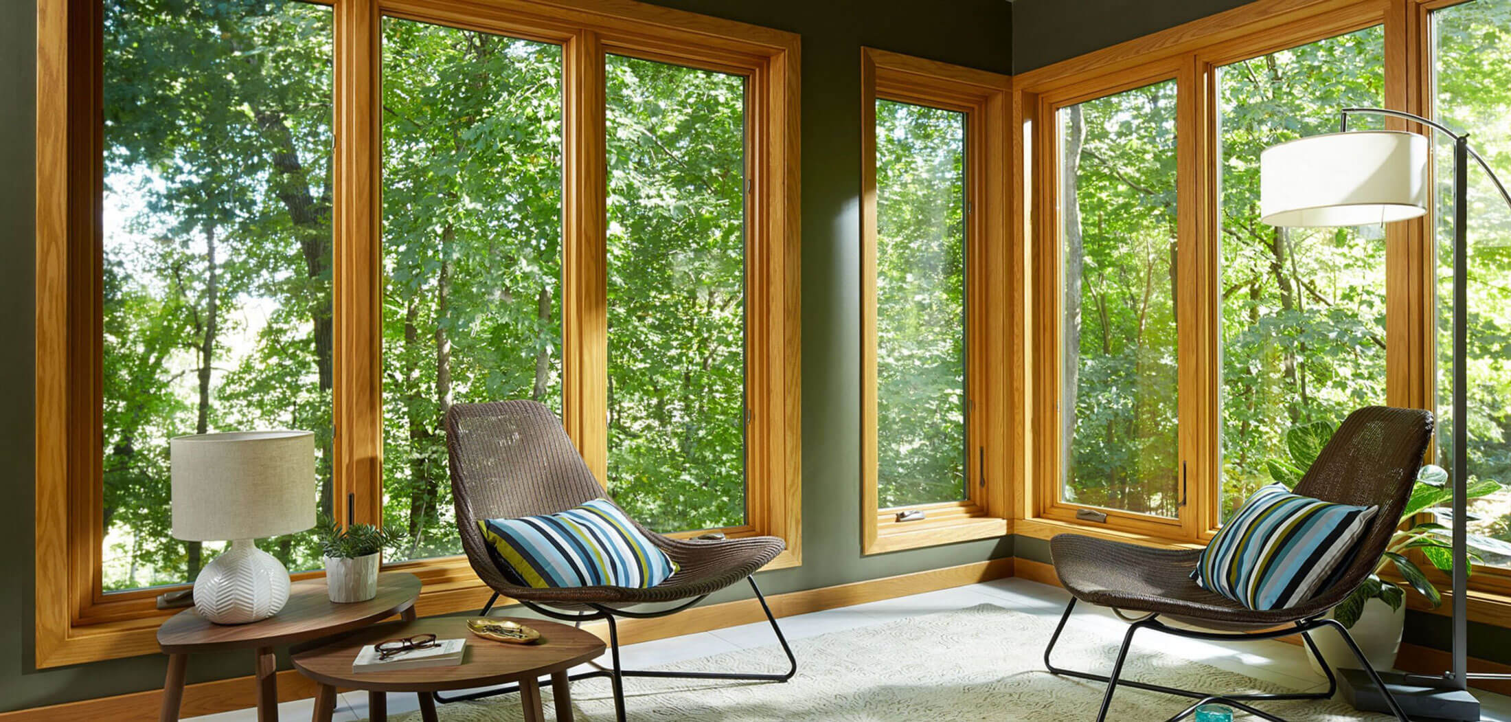 Sunroom with wood-frame windows overlooking the trees